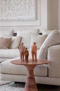 The Visitor small ceramic sculptures styled in an earth-toned living room